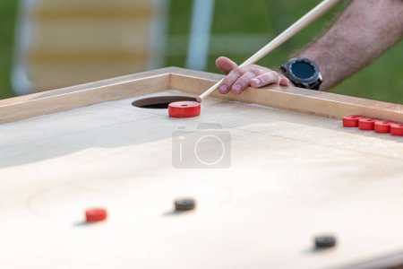 Téléchargez les photos : Men playing Novuss game. Novuss is a national sport in Latvia similar to pocket billiards or pool. - en image libre de droit