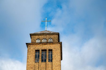 Téléchargez les photos : The bell tower of St. Ignatius Roman Catholic Church of Akn?ste on the background of the sky. Latvia - en image libre de droit