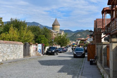 Photo for Mtskheta, Georgia - October 9, 2023: Tourists on street of old town Mtskheta near Svetitskhoveli Cathedral - Royalty Free Image