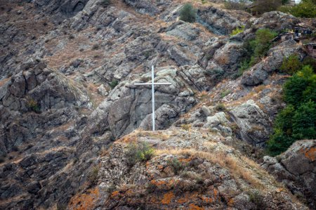 Photo for White commemorative cross on the top of the hill against the background of the mountain landscape - Royalty Free Image
