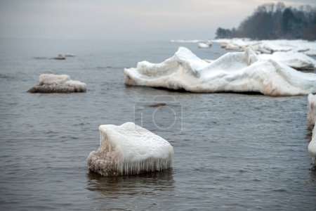 Frozen ice blocks in Baltic sea water on the shore, Kaltene, Latvia