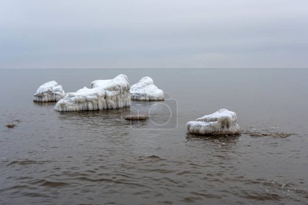 Landscape with ice hummocks and snow on a frozen Baltic Sea surface on a cold winter day