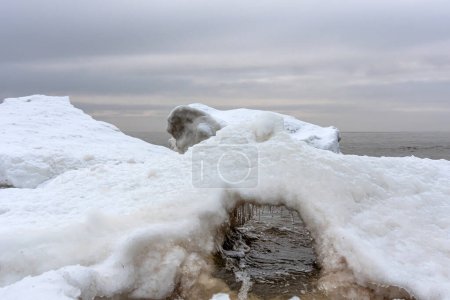 Close-up shot of the snow and ice formation in Baltic sea water on the shore, Kaltene, Latvia