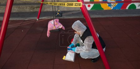 Photo for Crime scene in a childrens playground, where a child was kidnapped. the police present to catalog the evidence. swing and games seized - Royalty Free Image