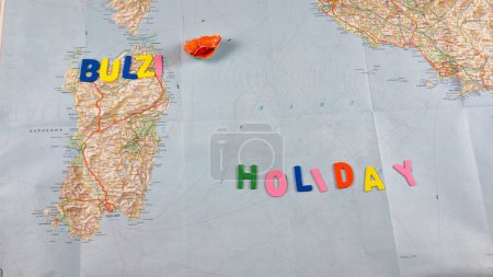 Photo for Italian paper travel geographical map with spinning toy car and the inscription holiday. High quality photo - Royalty Free Image
