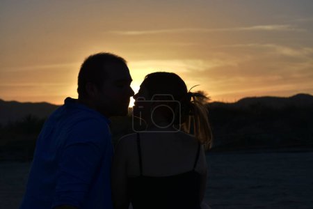 Photo for Back view of romantic couple at sunset - Royalty Free Image