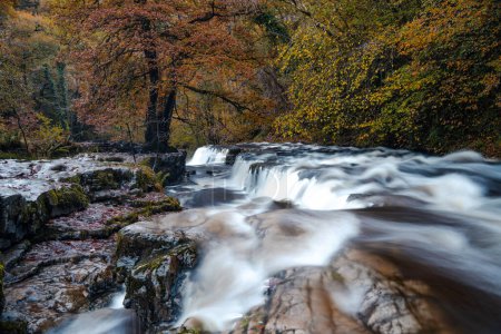 Photo for Sgwd y Pannwr waterfalls along the Four Waterfalls walk, Waterfall Country, Brecon Beacons national park, South Wales, the United Kingdom. Long exposure. - Royalty Free Image