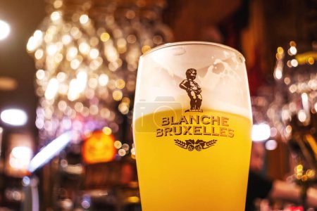 Photo for Blanche De Bruxelles Beer Glass with Bar background. Soft focus. Belgian White Beer. - Royalty Free Image