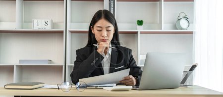 Asian business women are analyzing company sales statistical graphs to develop them further, Using laptops and data graphs to work, Tax, Vat , Professional female marketer