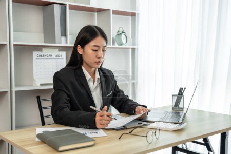 Asian business women are analyzing company sales statistical graphs to develop them further, Using laptops and data graphs to work, Tax, Vat , Professional female marketer