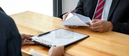 Photo for Dishonest cheating in business, Bribe employer is offer terms to the businessman for signing on contract while making corruption about buy land and real estate. - Royalty Free Image