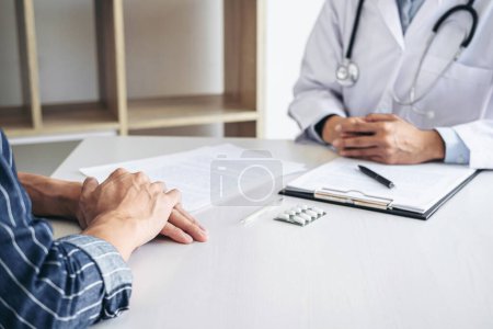 Photo for Doctor presenting report of diagnosis, symptom of disease and recommend something a method with patient treatment, after results about the problem illness of patient. - Royalty Free Image