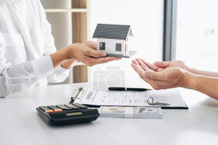 Home for rent, Broker agent präsentiert und berät den Kunden im Detail, um die Entscheidung zu treffen, ein Immobiliendarlehen an den Kunden unterzeichnen Vertrag und senden nach Hause Modell genehmigen und Geld erhalten.