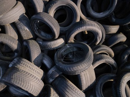 Aerial top down view of old tires. Many car and truck tires on dump site from above