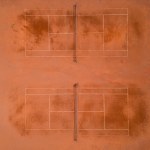 Aerial top view of empty tennis courts. Public sporting area outdoors from above.