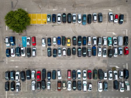 Photo for Drones aerial top down view reveals a densely packed parking lot filled with cars. Colorful dots form a pattern, reflecting the hustle of urban life. - Royalty Free Image