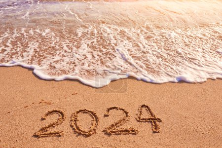 Photo for 2024 year drawing on sandy beach sea at sunny day - Royalty Free Image