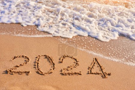 Photo for 2024 year drawing on sandy beach sea at sunny day - Royalty Free Image