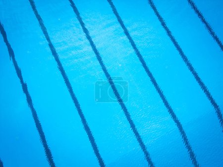 A blue swimming pool with distinct lines of water visible on the surface.
