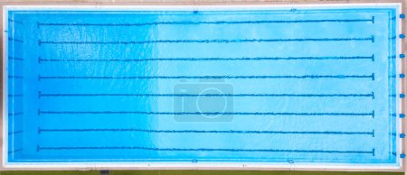A blue swimming pool with distinct lines of water visible on the surface.
