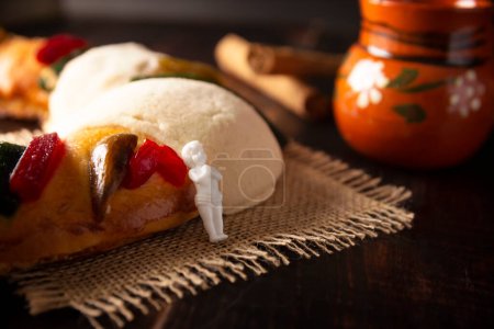 Photo for Traditional Kings day cake also called Rosca de Reyes, roscon, Epiphany Cake and with a clay Jarrito. Mexican tradition on January 5th - Royalty Free Image