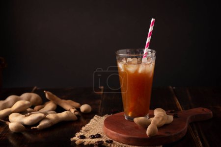 Photo for Agua de Tamarindo, is one of the traditional "Aguas Frescas" in Mexico. Infused drink made with tamarind to which beneficial health properties are attributed. - Royalty Free Image