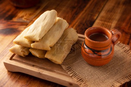 Photo for Tamales. Prehispanic dish typical of Mexico and some Latin American countries. Corn dough wrapped in corn leaves. The tamales are steamed. - Royalty Free Image