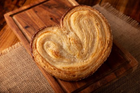Photo for Oreja. Mexican sweet bread made with puff pastry, its name comes from its shape similar to that of ears, of French origin, where it is known as Elephant Ear or Palmier Puff Pastry. - Royalty Free Image