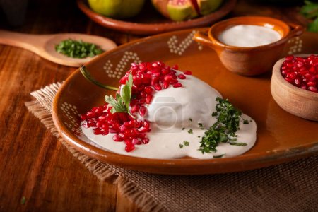 Chiles en Nogada, Typical dish from Mexico. Prepared with poblano chili stuffed with meat and fruits and covered with a walnut sauce. Named as the quintessential Mexican dish for national holidays.