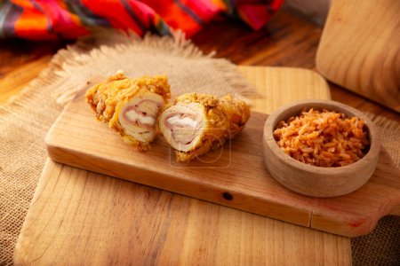 Photo for Chicken Cordon Bleu. Chicken breast meat wrapped with ham and cheese, breaded and fried or baked. Also known as schnitzel cordon bleu, a very popular recipe in many countries. - Royalty Free Image