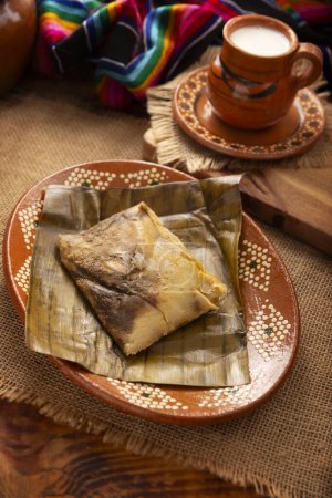 Photo for Oaxacan Tamales. Prehispanic dish typical of Mexico and some Latin American countries. Corn dough wrapped in banana leaves. The tamales are steamed. - Royalty Free Image