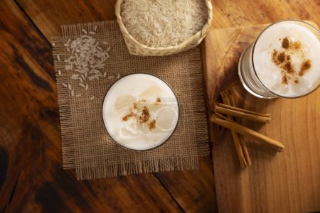 Photo for Horchata water. Also known as horchata de arroz, it is one of the traditional fresh waters of Mexico, it is made with rice and cinnamon. Traditionally prepared in a container called Vitrolero. - Royalty Free Image