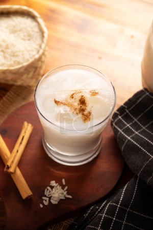 Photo for Horchata water. Also known as horchata de arroz, it is one of the traditional fresh waters of Mexico, it is made with rice and cinnamon. Traditionally prepared in a container called Vitrolero. - Royalty Free Image