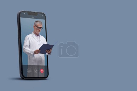 Photo for Professional doctor in a smartphone videocall and checking medical records, online doctor and telemedicine concept - Royalty Free Image
