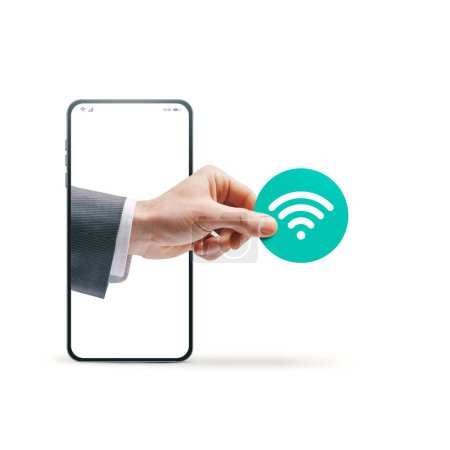 Foto de Mano de hombre de negocios saliendo de una pantalla de teléfono inteligente y sosteniendo un icono de Wi-Fi, concepto de conectividad, aislado sobre fondo blanco - Imagen libre de derechos