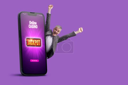 Photo for Big smartphone with online casino games interface on screen and cheerful winning man celebrating his victory, copy space - Royalty Free Image