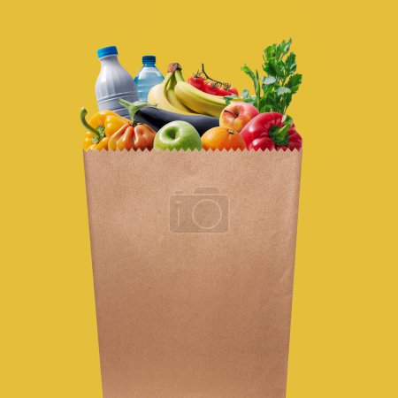 Paper grocery bag full of groceries: food and retail concept