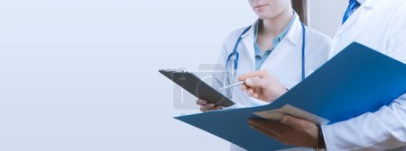 Photo for Doctors checking a patient's medical records, medicine and healthcare concept, banner with copy space - Royalty Free Image