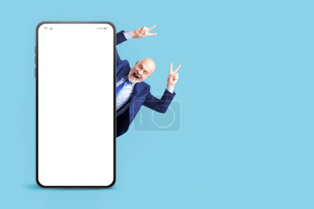 Photo for Successful businessman celebrating with arms raised and big smartphone with blank screen, marketing and business concept - Royalty Free Image