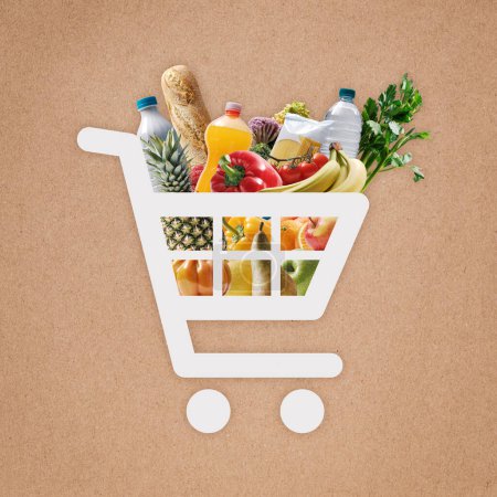 Photo for Online shopping app: shopping cart icon full of fresh groceries, brown paper in the background - Royalty Free Image