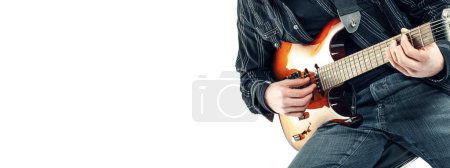 Téléchargez les photos : Guitarist sitting and playing electric guitar, isolated on white background, copy space - en image libre de droit