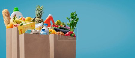 Paper grocery bags full of groceries: commerce and retail concept