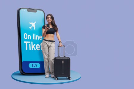 Foto de Young happy woman booking air tickets online using a mobile app, travel and tourism concept - Imagen libre de derechos