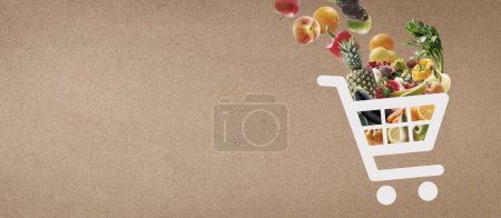 Photo for Online grocery shopping banner with shopping cart full of groceries - Royalty Free Image