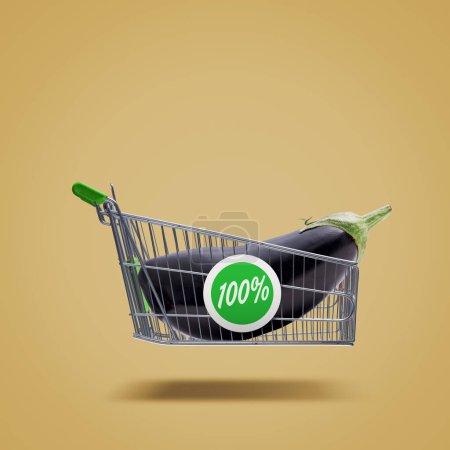 Foto de Flying shopping cart with fresh eggplant, organic vegetables and grocery shopping concept - Imagen libre de derechos