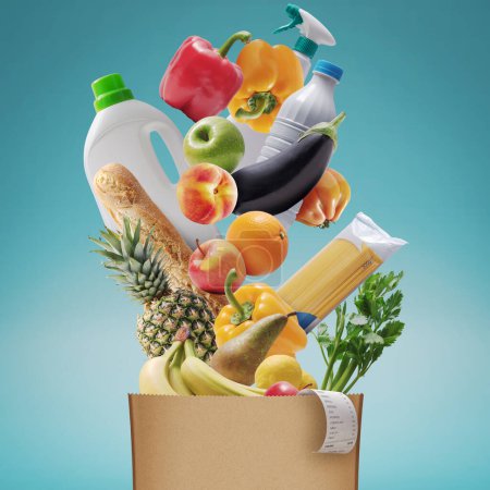Foto de Surtido de comestibles frescos que caen en una bolsa de papel, concepto de compras de comestibles - Imagen libre de derechos