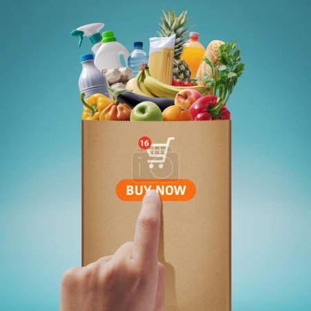 Photo for Customer ordering grocery online, she is pressing the buy now button - Royalty Free Image