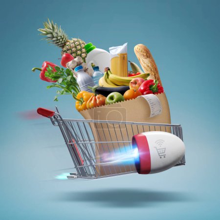 Foto de Fast rocket-propelled shopping cart flying and delivering fresh groceries, online grocery shopping and express delivery concept - Imagen libre de derechos