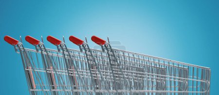 Téléchargez les photos : Many supermarket shopping carts in a row, grocery shopping concept - en image libre de droit