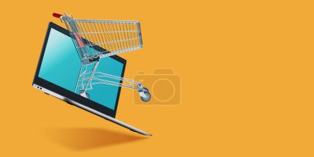 Téléchargez les photos : Shopping cart coming out of a laptop screen: online shopping website, banner with copy space - en image libre de droit